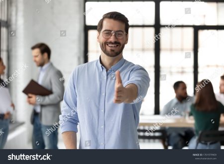 Young man reaching out his arm to shake hands