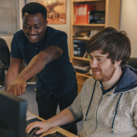 Two EDA Solutions engineers working together at a compute monitor