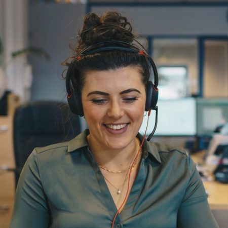 Young lady helping customer on the support phone line